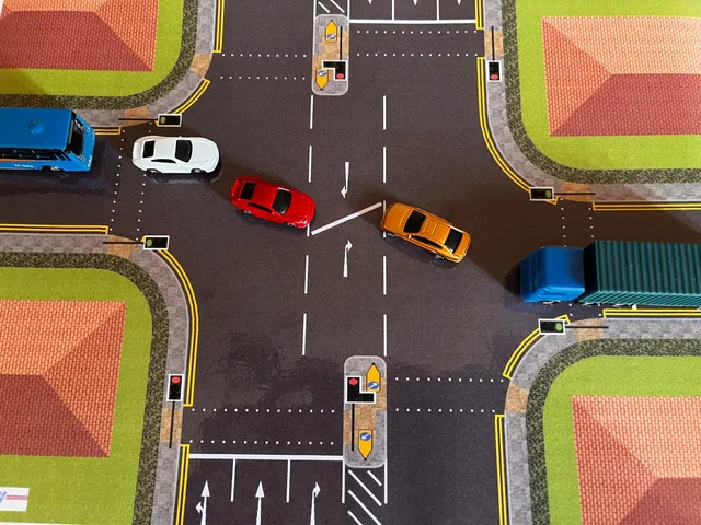 Demonstrating V.I.A. Kit, by having two cars meeting up at the staggered crossroads, and positioning over vehicles near by that's included with the kit.