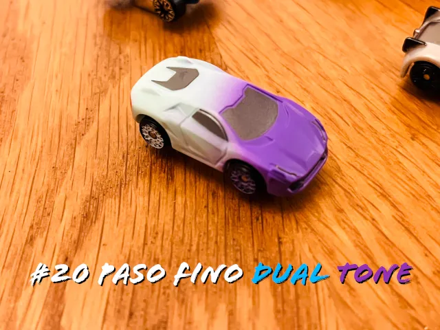 A carousel photo displaying the twentieth vehicle named 'Paso Fino Dual Tone' out of an array of 'Deluxe Cars', at full size. The car is painted half purple, half white.