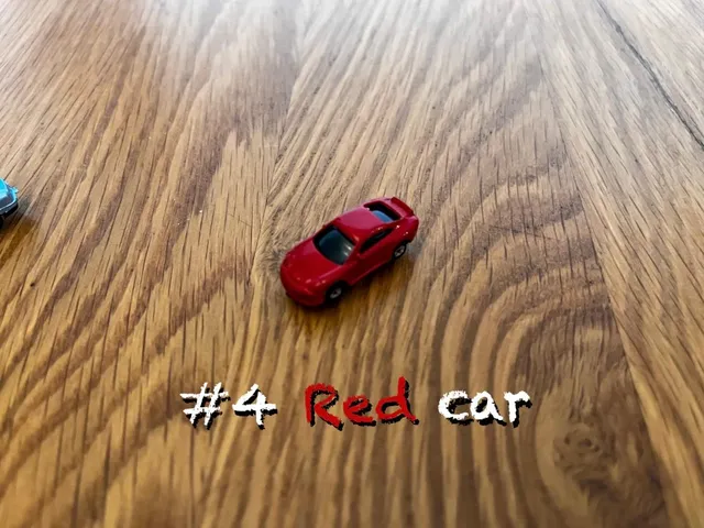 A carousel photo displaying the fourth car named 'Red car' out of an array of V.I.A. 'mini Standard cars', at mini size. The car is painted dark-red with a standard SUV design.