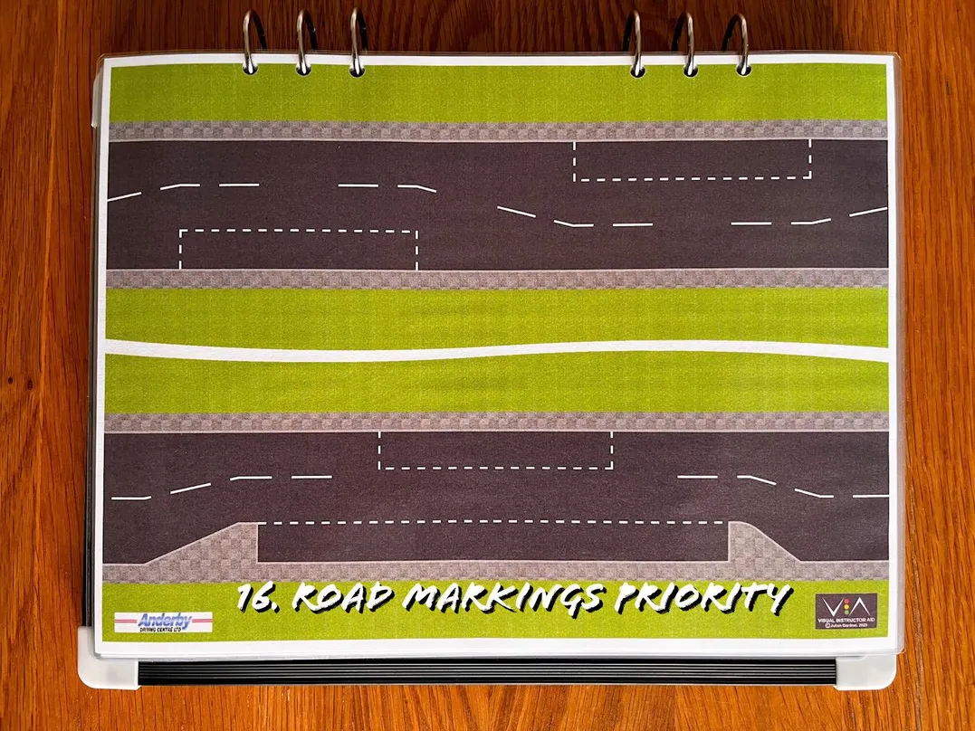 A carousel photo displaying the sixteenth plan named 'road markings priority' out of an array of roads layouts, at full size. Consisting of marking priority areas within the two carriageways.